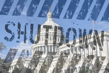 The letters SHUTDOWN over top of an image of the Capital Building.