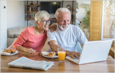 Couple at table with laptop