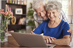 Husband and wife looking at laptop