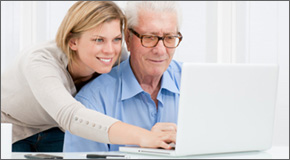 Daughter and father looking at laptop