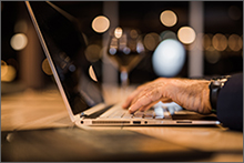 Elder hands on a laptop