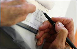 Hands writing a check
