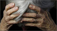 Elder with head in hands