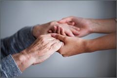 Caregiver hands helping elder