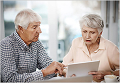 Elder couple at laptop