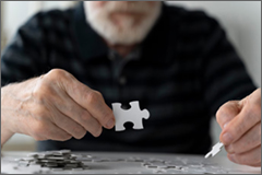 Elder gentleman building a puzzle