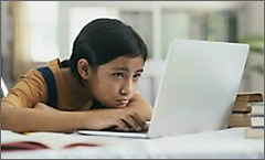 Young girl looking at laptop