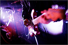 Close-up of a musician playing the electric guitar during a concert.