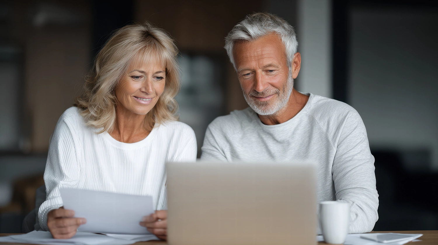 Senior couple viewing credit bureaus on their laptop